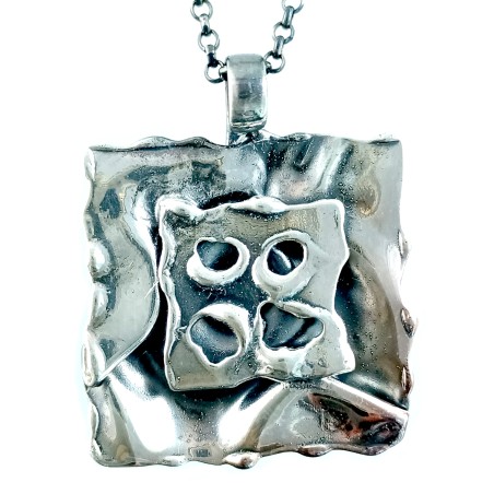 Création de bijoux artisanaux : petit pendentif en argent vieilli.