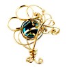 Broche dorée avec une pierre bleue, bijou artisanal.